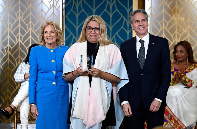 Ms Biden and Mr Blinken with Alba Rueda, an honouree from Argentina. AFP