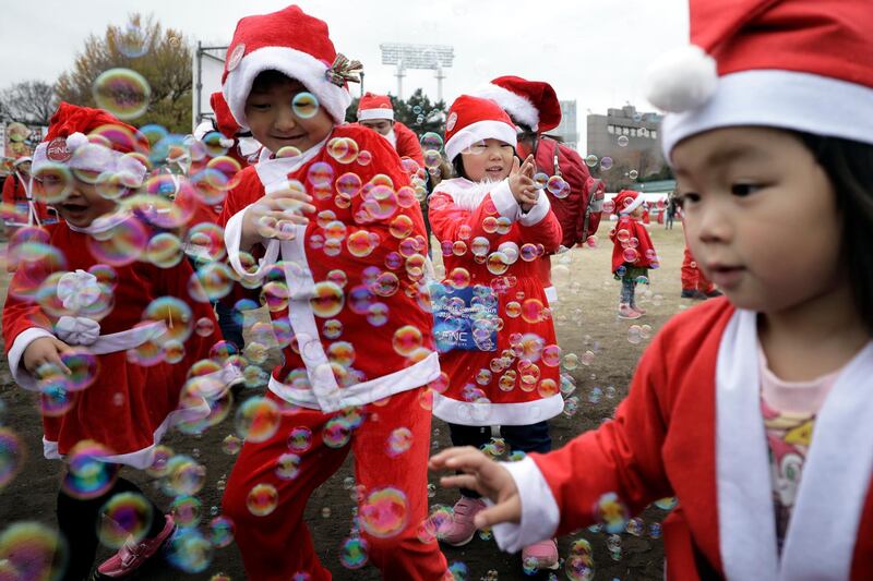 A group of children play with bubbles prior to the event. EPA