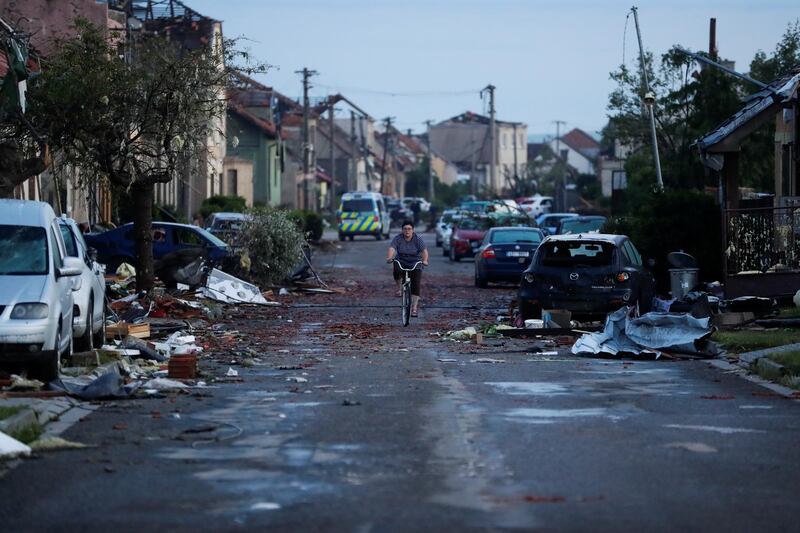 A cyclist rides past debris from a tornado in the Czech village of Moravska Nova Ves. Reuters