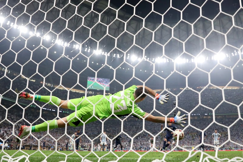 Argentina goalkeeper Emiliano Martinez is beaten by the penalty of France's Kylian Mbappe. Getty