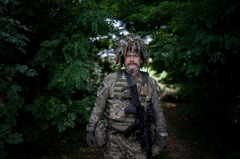 A Ukrainian soldier nicknamed 'Oakland' guards his position at the front line in the Kharkiv region. AP