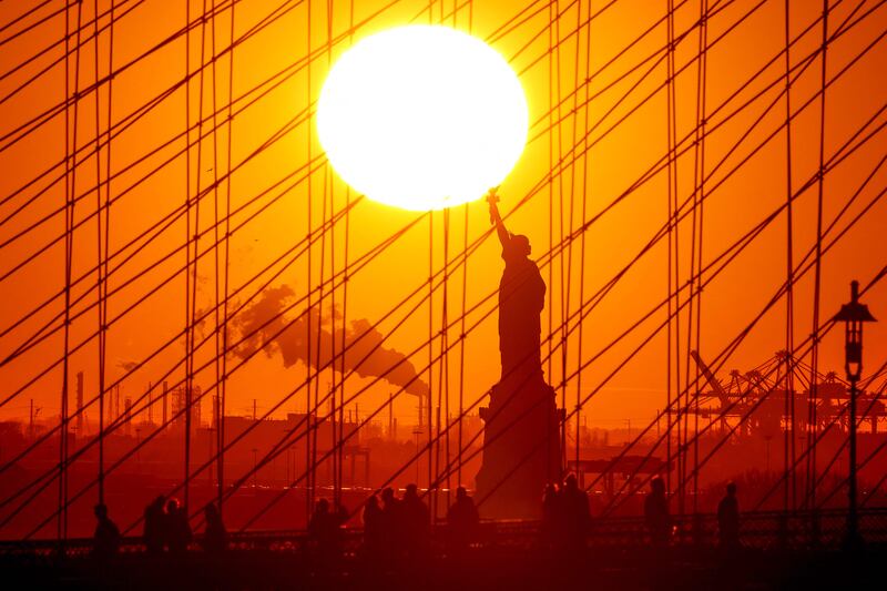 The sun sets behind the Statue of Liberty in New York. AFP