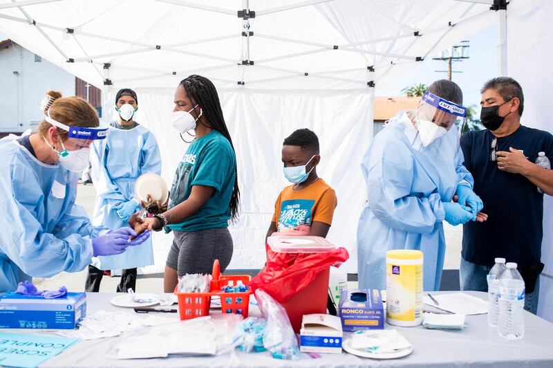 People receive Covid-19 antibody tests during a free testing session in honour of Dr. Martin Luther King, Jr. at Southside Church of Christ in Los Angeles. AP Photo