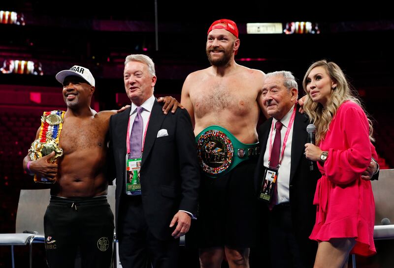 Tyson Fury poses for a photograph with promoters Frank Warren and Bob Arum, trainer SugarHill Steward and commentator, Crystina Poncher. Reuters