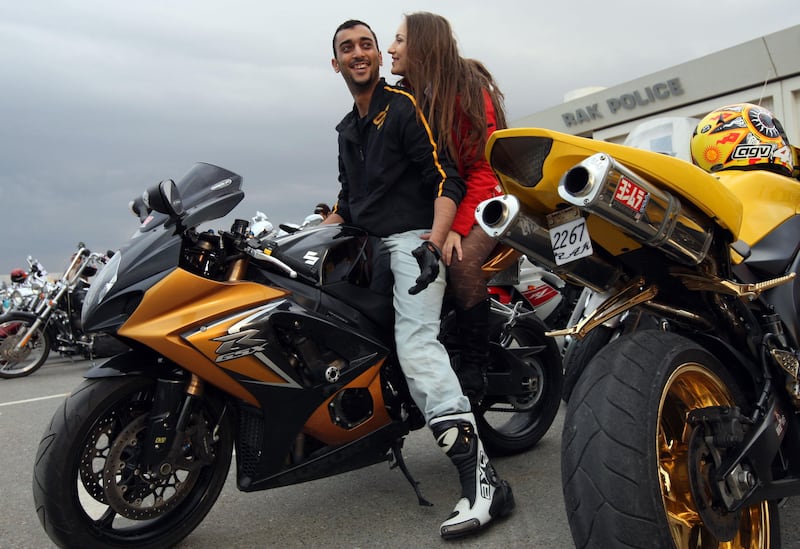 United Arab Emirates - Ras Al Khaimah - Jan. 23, 2009:

Mohammed Alshaer (cq-al), 26, and Cristina (cq-al) Turcan (cq-al), 23, both of Dubai, arrive on Alshaer's Suzuki 1000 GSX-R motorcycle to participate in the Carnival of Classic Motorcycles as part of the Festival of Awafi 2009 in Ras Al Khaimah outside the police and traffic department building on Friday, Jan. 23, 2009. Amy Leang/The National  



