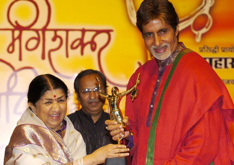 Mangeshkar presenting the annual Pundit Dinanath Mangeshkar Memorial award to film star Amitabh Bachchan in 2005. AFP