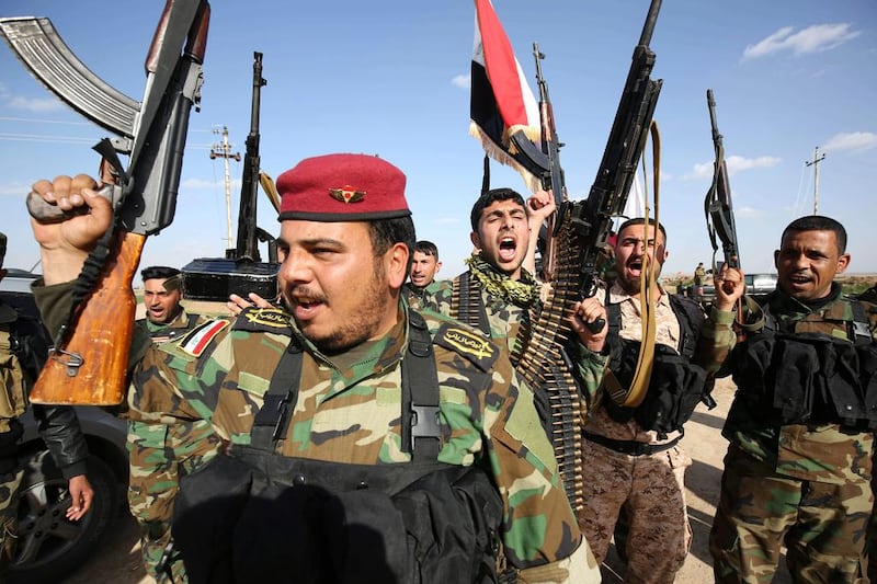Shiite militia fighters sing anti-ISIL songs on the frontline near Kirkuk, Iraq. AP Photo/Emad Matti