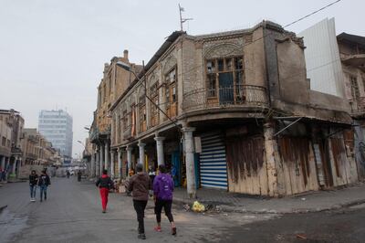 In this Monday, Dec. 16, 2019 photo, with the major part of the shops are closed, cement blocks close the commercial and historic al-Rasheed street, in the center of Baghdad, Iraq.  With Iraq's leaderless uprising now in its third month, the protracted street hostilities, internet outages, blocked roads and a general atmosphere of unease are posing risks to Iraq's economy. In particular, the unrest has set back the most fragile segment of the country's economy, the private sector, where business owners have faced losses from damage to merchandise and disruptions of markets and from consumers reeling in their spending out of fear for the future. (AP Photo/Nasser Nasser)