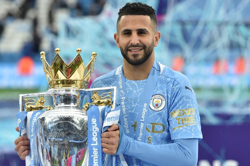 Manchester City's Algerian midfielder Riyad Mahrez holds the Premier League trophy during the award ceremony after the English Premier League football match between Manchester City and Everton at the Etihad Stadium in Manchester, north west England, on May 23, 2021. RESTRICTED TO EDITORIAL USE. No use with unauthorized audio, video, data, fixture lists, club/league logos or 'live' services. Online in-match use limited to 120 images. An additional 40 images may be used in extra time. No video emulation. Social media in-match use limited to 120 images. An additional 40 images may be used in extra time. No use in betting publications, games or single club/league/player publications.
 / AFP / POOL / PETER POWELL                         / RESTRICTED TO EDITORIAL USE. No use with unauthorized audio, video, data, fixture lists, club/league logos or 'live' services. Online in-match use limited to 120 images. An additional 40 images may be used in extra time. No video emulation. Social media in-match use limited to 120 images. An additional 40 images may be used in extra time. No use in betting publications, games or single club/league/player publications.
