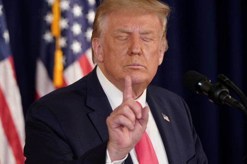 US President Donald Trump gestures after signing executive orders for economic relief during a news conference at his golf resort in Bedminster, New Jersey, US. Reuters