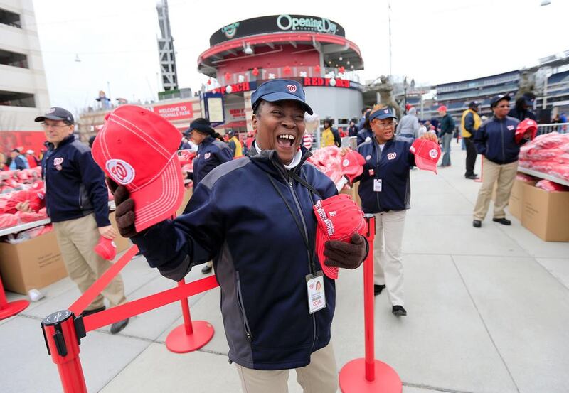 Christine Palmer hands out hats as fans enter the stadium before the start of the Washington Nationals and Atlanta Braves home opener at Nationals Park on Friday in Washington, DC, USA.  Rob Carr / Getty Images / AFP / April 4, 2014 
