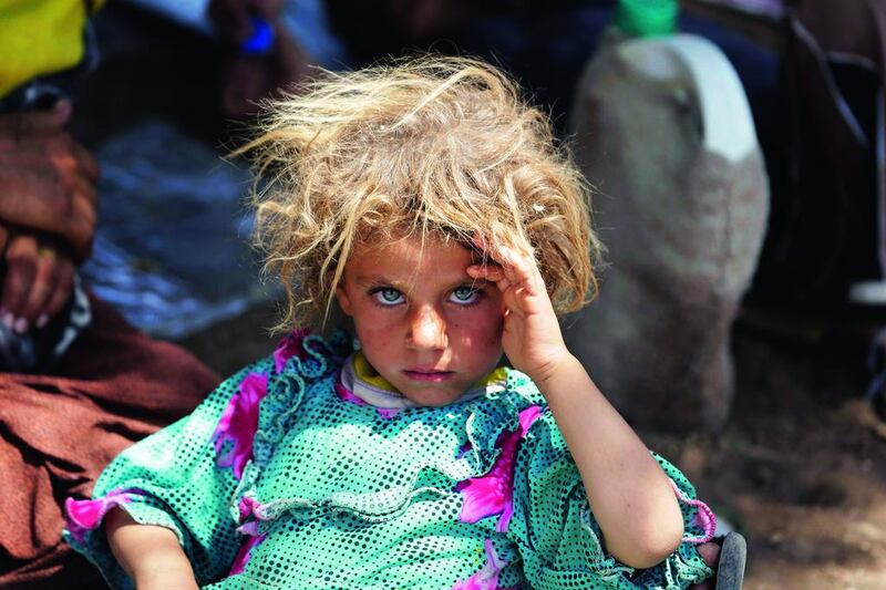 A girl from the minority Yazidi sect rests after fleeing violence in Sinjar, in this August 13 file photo. Youssef Boudlal / Reuters