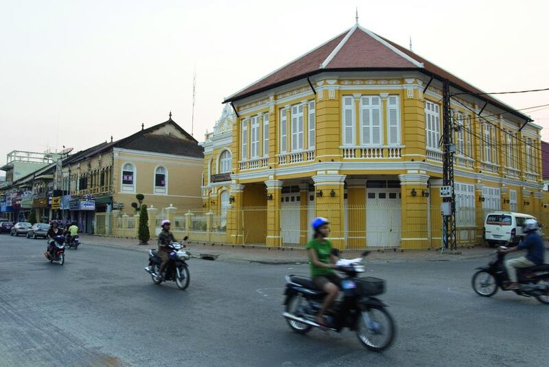 Girls ride scooters past old French Colonial buildings in Battambang, the capital of Battambang Province and second largest city in Cambodia. Getty Images