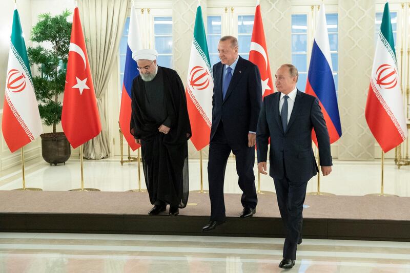 From left, Iranian President Hassan Rouhani, Turkish President Recep Tayyip Erdogan and Russian President Vladimir Putin after posing for a photo in Ankara, Turkey, Monday, Sept. 16, 2019. The leaders of Russia, Iran and Turkey met in Ankara to discuss the situation in Syria, with the aim of halting fighting in the northwestern Idlib province and finding a lasting political solution to the country's civil war, now in its ninth year. (AP Photo/Pavel Golovkin, Pool)