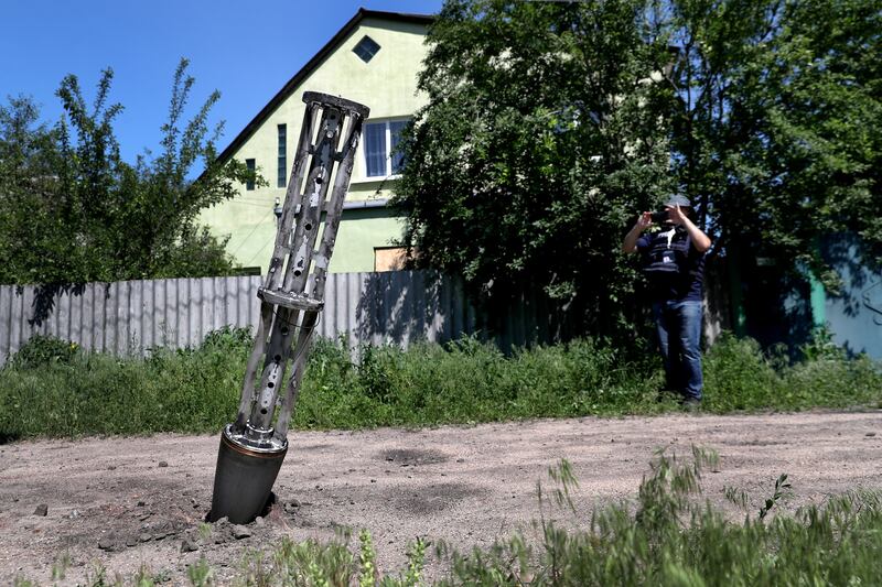 An empty cluster munition container stuck in the ground after a military strike on the outskirts of Kharkiv, Ukraine. Reuters