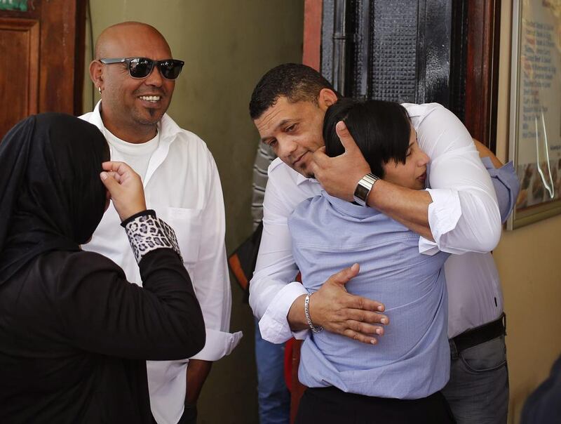 Morne and Celeste Nurse hug outside of court in Cape Town after a judge handed a 10-year jail sentence to a woman who kidnapped their newborn girl almost 20 years ago. Schalk van Zuydam / AP Photo