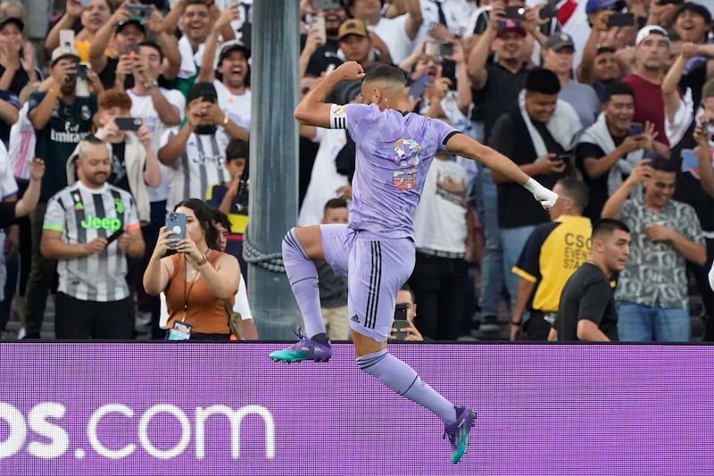 Karim Benzema leaps in celebration after scoring on a penalty against Juventus. AP