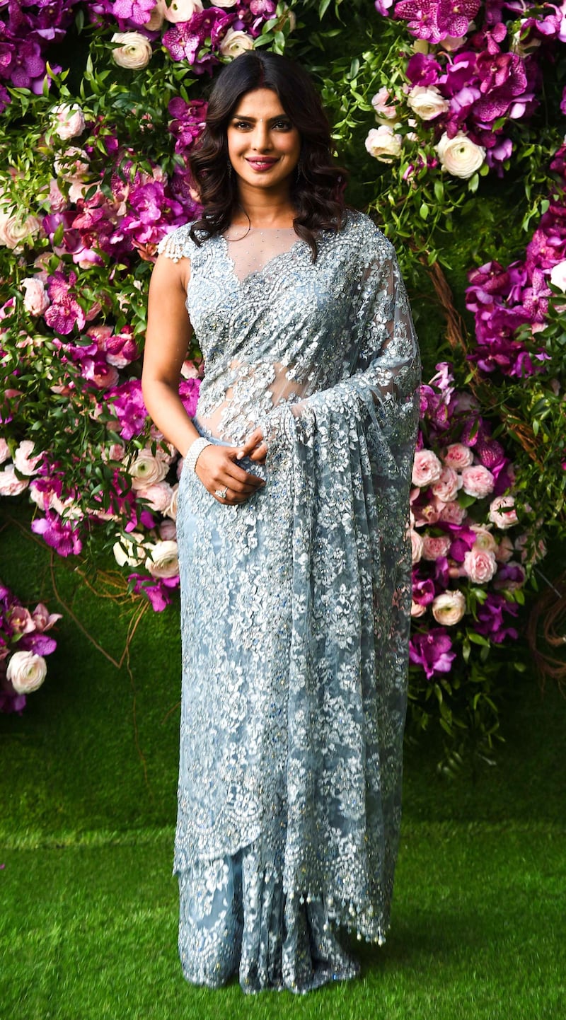 Bollywood actress Priyanka Chopra poses for photographs as she arrives to attend the wedding ceremony of Akash Ambani, son of Indian businessman Mukesh Ambani, in Mumbai on March 9, 2019. Photo: AFP