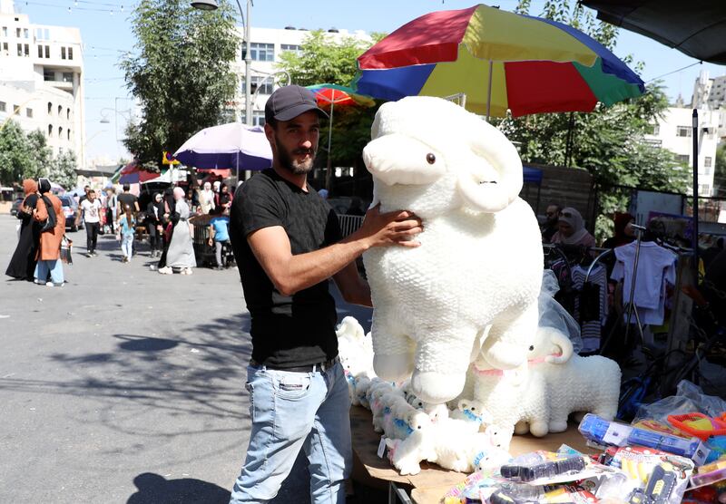 A stallholder sells soft toys ahead of Eid Al Adha, at a market in the West Bank city of Hebron. EPA