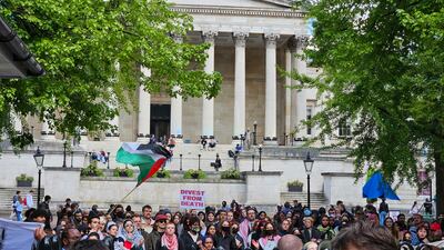 Students held banners telling University College London to 'divest from death' and calling it complicit in genocide. Tim Stickings / The National