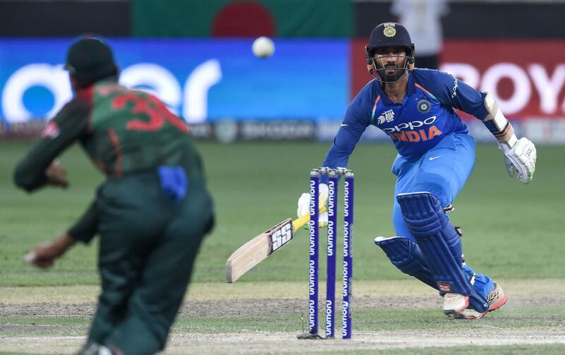 Indian batsman Dinesh Karthik (R) runs between the wickets during the final one day international (ODI) Asia Cup cricket match between Bangladesh and India at the Dubai International Cricket Stadium in Dubai on September 28, 2018. / AFP / ISHARA S. KODIKARA
