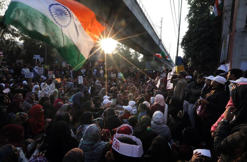 Indian activists hold placards and shout slogans as they protest against Citizen Amendment Act(CAA) outside Jamia Millia Islamia University, in New Delhi.  EPA