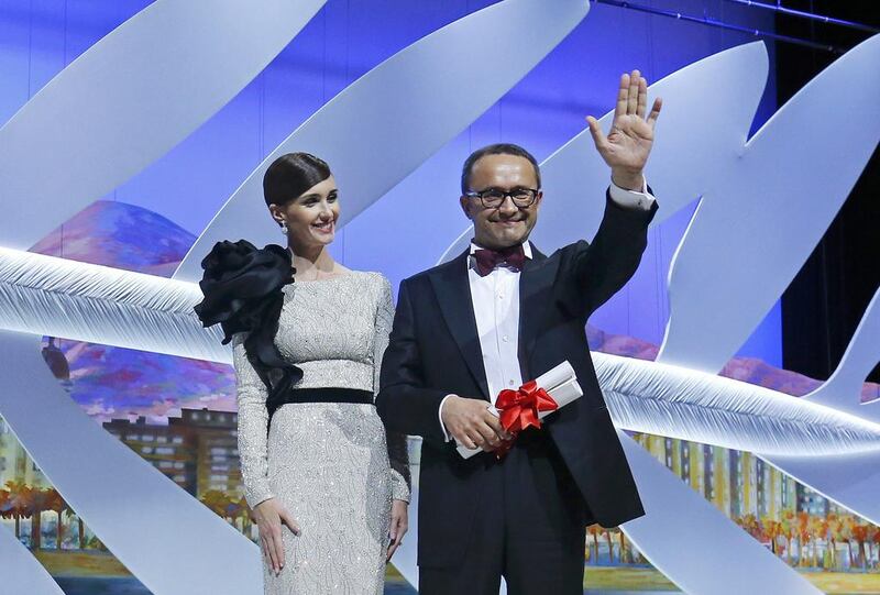 Director Andrey Zvyagintsev, Best screenplay award winner for his film Leviathan (Leviafan), celebrates on stage next to Spanish actress Paz Vega. Reuters