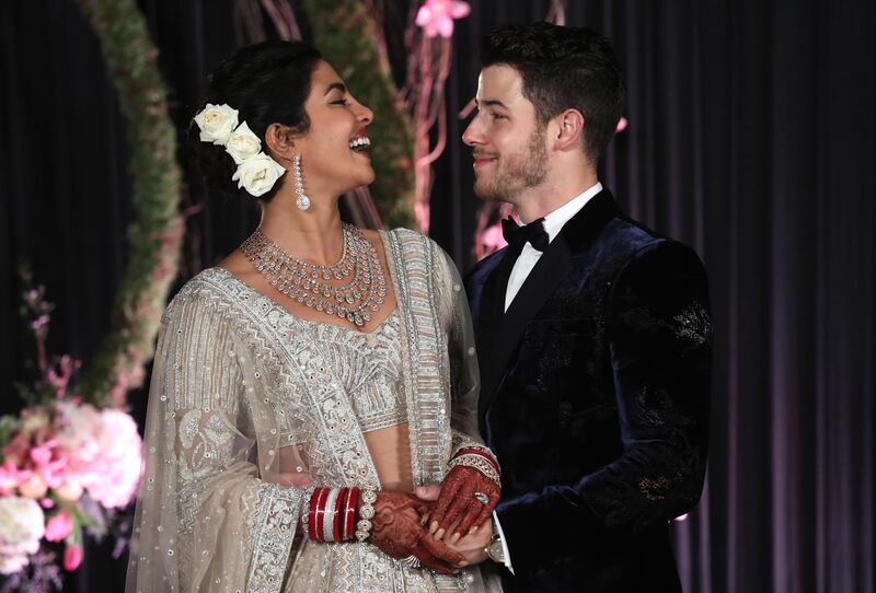 Newlyweds Priyanka Chopra, 36, and Nick Jonas, 26, pose for a photograph during a reception at a hotel in New Delhi on December 4, 2018. Photo: EPA