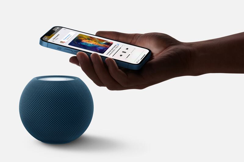 The HomePod mini works with iPhone to hand off music or receive personalised listening suggestions when a device is near by. Photo: EPA