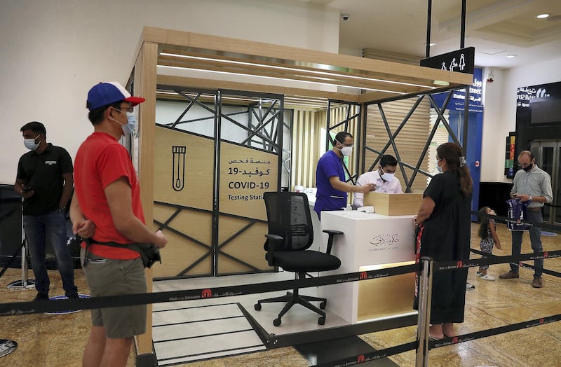 DUBAI, UNITED ARAB EMIRATES , October 14 – 2020 :- People taking their token for the COVID-19 nasal swab test at the COVID 19 testing station set up at Mall of the Emirates in Dubai. (Pawan Singh / The National) For News/Online. Story by Sarwat