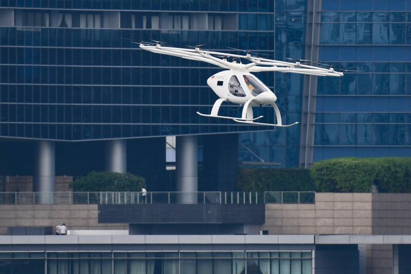 A Volocopter unmanned air taxi transport flies over Marina Bay during test flight with a safety pilot at the 26th Intelligent Transport Systems World Congress (ITSWC) in Singapore. AFP