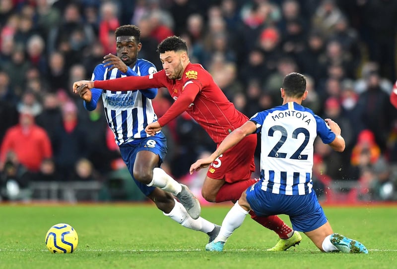 Liverpool's Alex Oxlade-Chamberlain (centre) and Brighton and Hove Albion's Martin Montoya (right) battle for the ball during the Premier League match at Anfield, Liverpool. PA Photo. Picture date: Saturday November 30, 2019. See PA story SOCCER Liverpool. Photo credit should read: Anthony Devlin/PA Wire. RESTRICTIONS: EDITORIAL USE ONLY No use with unauthorised audio, video, data, fixture lists, club/league logos or "live" services. Online in-match use limited to 120 images, no video emulation. No use in betting, games or single club/league/player publications.