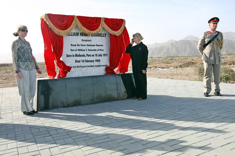 United Arab Emirates- Fujairah - January 27, 2010:

NATIONAL: A memorial to Sergeant William Donnelly (cq-al), a member of Britain's Royal Air Force who was killed when his plane crashed in Sayh Dhadnah in the emirate of Fujairah during World War II, is dedicated by his great niece Lesley Botten (cq-al), of Kinross, Scotland, left, and his niece (Lesley's mother) June Botten (cq-al), of Reading, England, center, as well as a member of the British Royal Air Force  on Wednesday, January 27, 2010 in Fujairah . "When I first read the report of how the accident first happened," said Lesley, who is the family history buff. "It brings it very much to life. The pilot noticed a small problem. There was an oil leak. He turned around. They lost a propeller. You start to think about what was going on in their minds." Amy Leang/The National *** Local Caption ***  amy012710mem01 copy.jpg