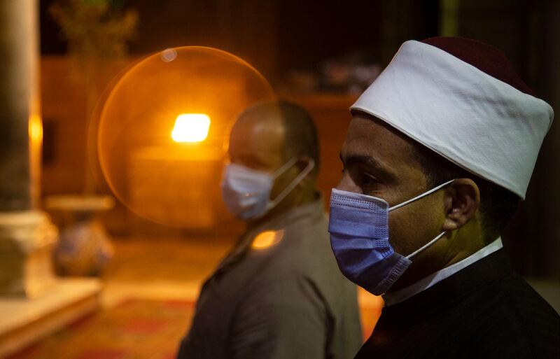 Worshippers wait to perform dawn prayers at the Amr Ibn Al-As in Cairo.  EPA