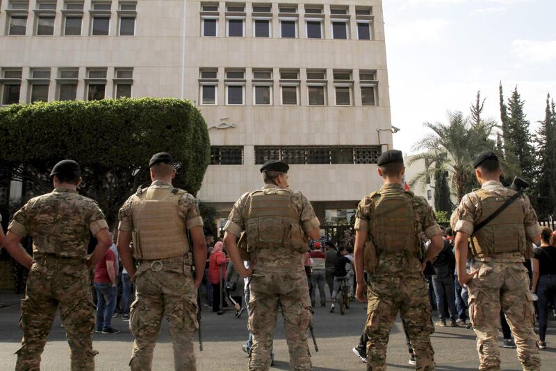 Lebanese army soldiers stand guard during an anti-government demonstration in front of the central bank building in the southern Lebanese city of Sidon. AFP