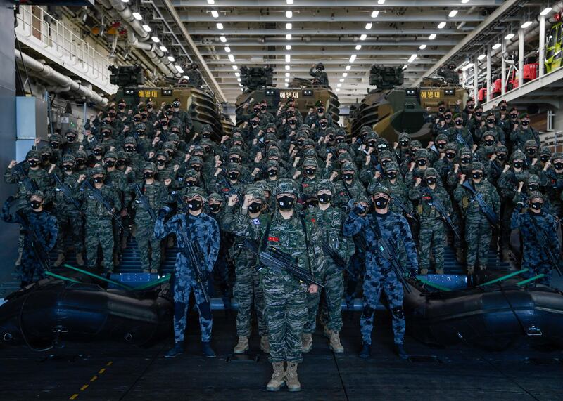 A group of South Korean Marines posing for a photo before they set sail on an amphibious assault ship, the 'Marado', from a naval base on Jeju Island, South Korea.  EPA