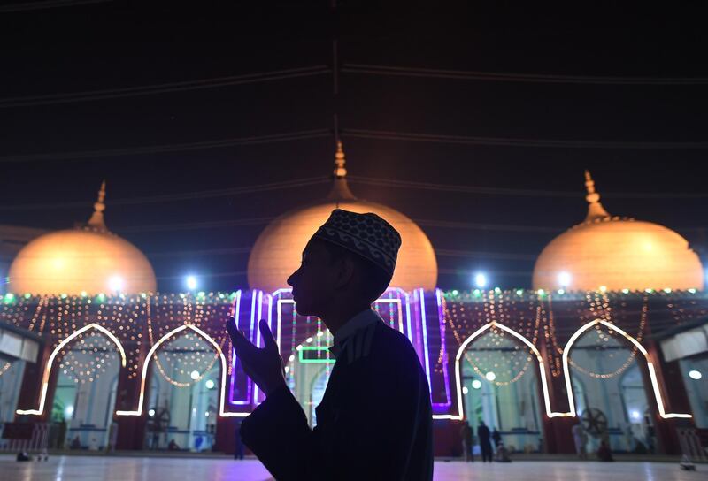 A Pakistani Muslim prays at an illuminated mosque in connection with Eid-e-Milad-un-Nabi, the birthday of Prophet Mohammad, in Karachi on November 20, 2018. AFP