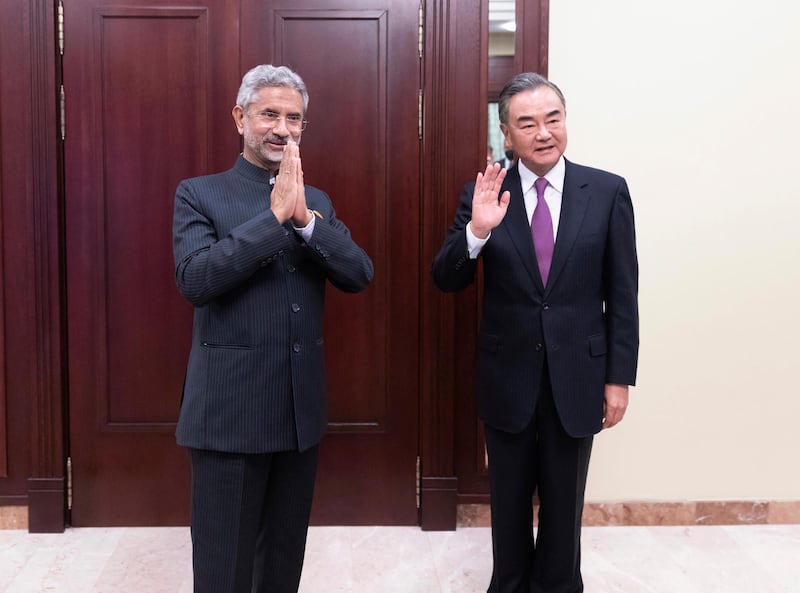 In this photo released by China's Xinhua News Agency, India's External Affairs Minister Subrahmanyam Jaishankar, left, and Chinese Foreign Minister Wang Yi pose for a photo as they meet on the sidelines of a meeting of the foreign ministers of the Shanghai Cooperation Organization (SCO) in Moscow, Russia on  Sept. 10, 2020. The Indian and Chinese foreign ministers have agreed that their troops should disengage from a tense border standoff, maintain proper distance and ease tensions in the Ladakh region where the two sides in June had their deadliest clash in decades. (Bai Xueqi/Xinhua via AP)