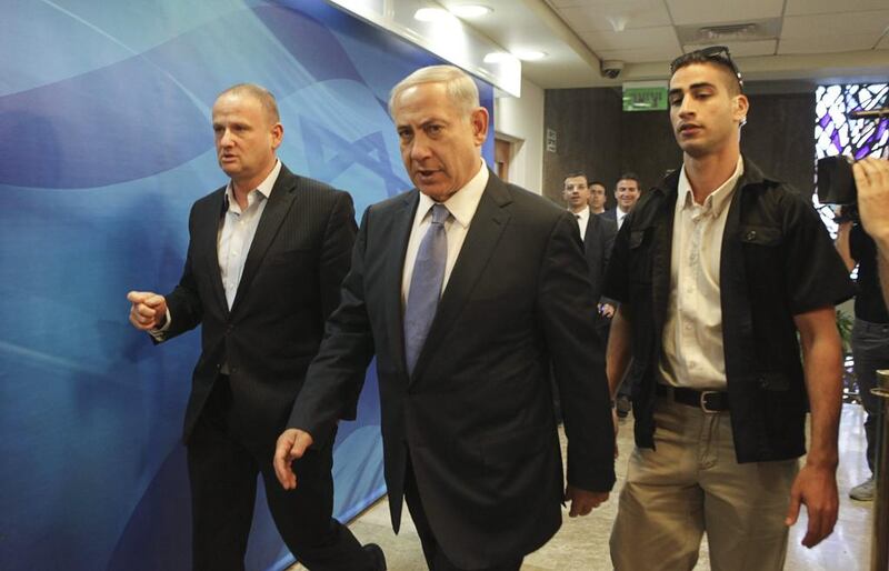 Israeli prime minister Benjamin Netanyahu, centre, arrives at a cabinet meeting to discuss public disorder in Jerusalem on Tuesday. Dan Balilty / Reuters
