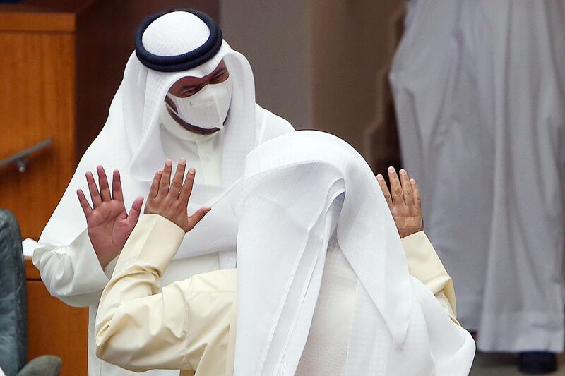 Kuwaiti MPs, wearing protective masks, arrive to a parliament session at the national assembly in Kuwait City, on June 16, 2020. / AFP / YASSER AL-ZAYYAT
