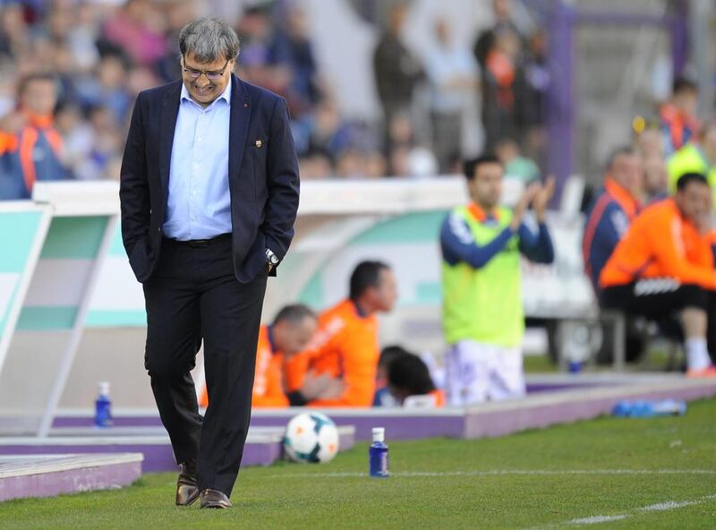 Barcelona's coach Gerardo Martino can only grimace and stare at his feet as they fall to Real Valladolid 1-0 in their Primera Liga match on March 8, 2014. Israel L Murillo / AP Photo