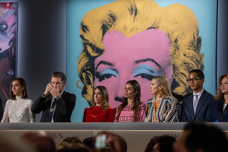 Staffers work the phones for bids on 'Shot Sage Blue Marilyn' by Andy Warhol during an Evening Sale of works from The Collection of Thomas and Doris Amman at Christie's Auction House in New York. EPA