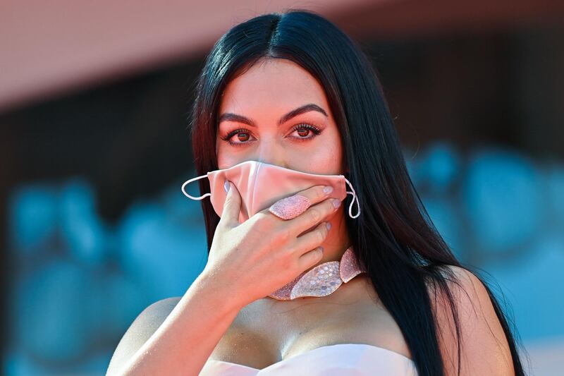 Georgina Rodriguez holds her face mask as she arrives for the screening of 'The Human Voice' on the second day of the 77th Venice Film Festival, on September 3, 2020 at Venice Lido. AFP