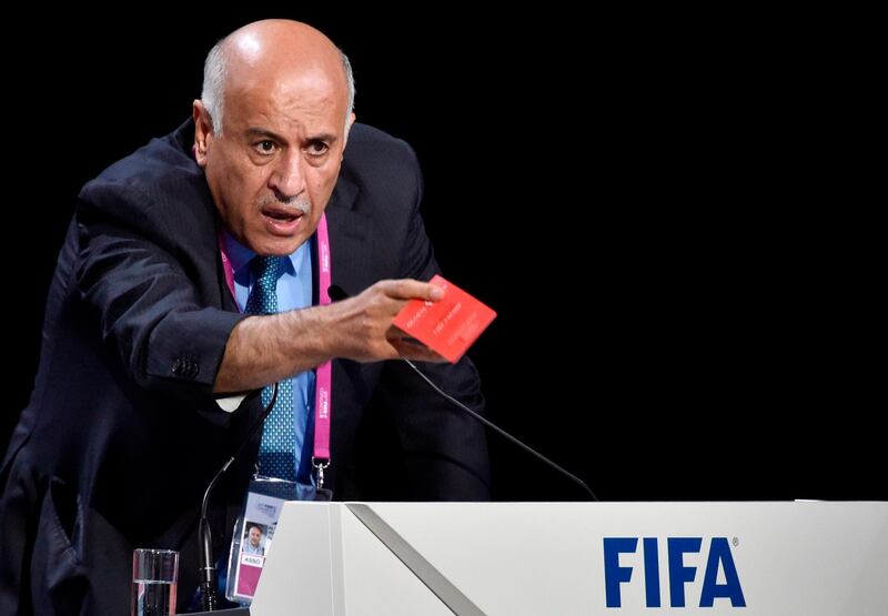 (FILES) In this file photo taken on May 29, 2015 Palestinian football chief Jibril Rajoub shows a red card as he speaks during the 65th FIFA Congress on May 29, 2015 in Zurich. - FIFA said on August 24, 2018 that it has started disciplinary proceedings against the Palestinian Football Association's chief, Rajoub, after he called for protest against Lionel Messi and his plan to play with Argentina in Jerusalem. (Photo by Michael BUHOLZER / AFP)