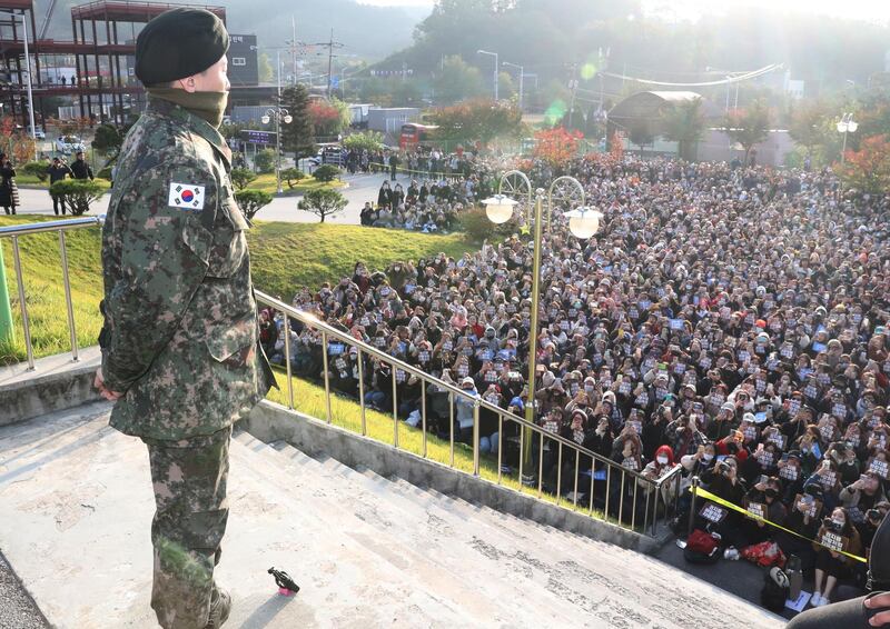 G-Dragon (L), a member of South Korean boy band BIGBANG, looks at fans who came to greet his discharge from mandatory military service at a military base in Yongin, South Korea, 26 October 2019. EPA