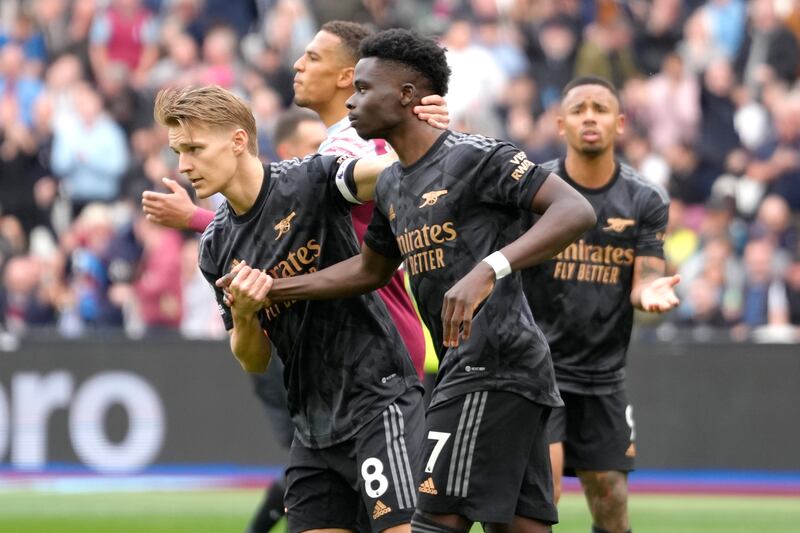 Arsenal's Martin Odegaard, left, puts his arm around Bukayo Saka after Saka's missed penalty. AP Photo
