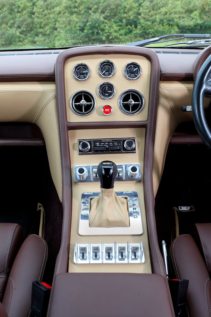 The Jensen Interceptor R features a new dashboard, with toggle switches, electric windows and mirrors, infotainment with Bluetooth connectivity, and a big red starter button