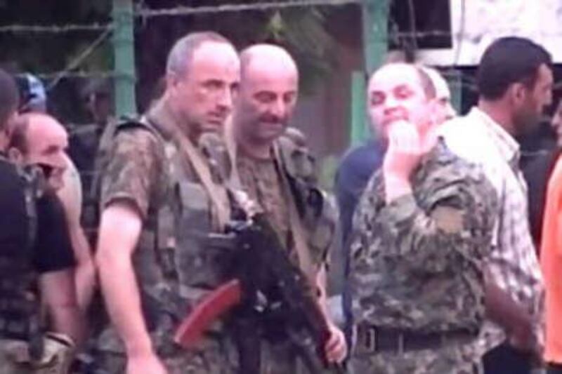 A Russian NTV channel television grab shows Abkhaz soldiers standing on a street in the Georgian breakaway Abkhazia region in Sukhumi yesterday. Rebel forces in Abkhazia launched a new attack on Georgian troops today in a sliver of the breakaway region held by Tbilisi, Interfax news agency reported, citing Abkhaz separatists.