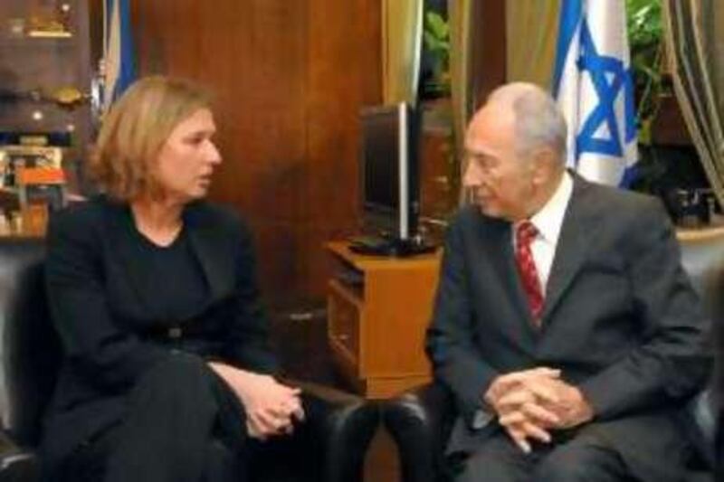 In this photo released by the Israeli Government Press Office, Prime Minister-designate Tzipi Livni, left, meets with Israel's President Shimon Peres, right, at his Jerusalem residence, Monday, Oct. 20, 2008. Livni has asked Peres to give her two more weeks to put together a coalition government.(AP Photo/ GPO, Moshe Milner, HO) **ISRAEL OUT** *** Local Caption ***  JRL801_MIDEAST_ISRAEL_PALESTINIANS_OBAMA.jpg