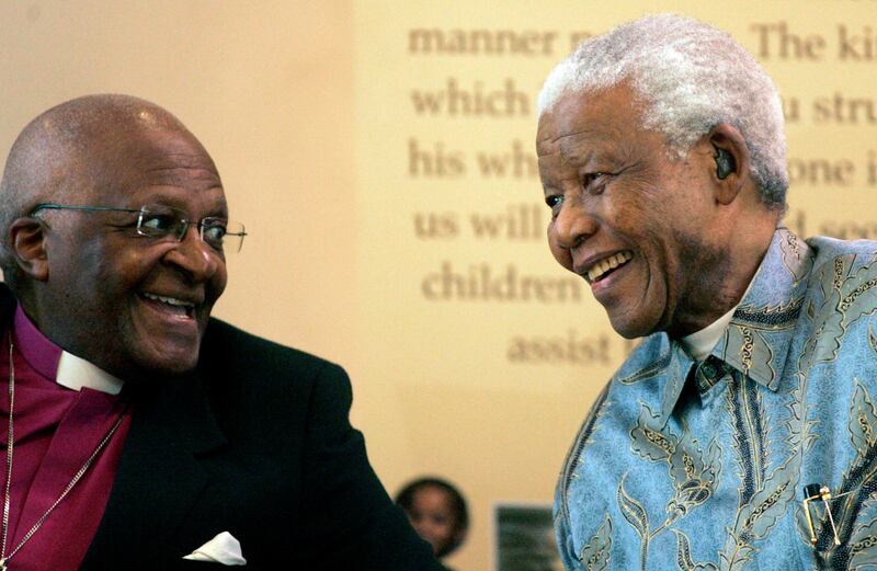 Former South African President Nelson Mandela, right, reacts with Archbishop Desmond Tutu, left, during the launch of a Walter and Albertina Sisulu exhibition, called, 'Parenting a Nation', at the Nelson Mandela Foundation in Johannesburg, South Africa, Wednesday, March 12, 2008. (AP Photo/Themba Hadebe)